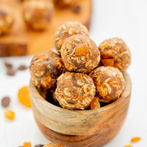 A small wooden bowl of apricot oat balls.