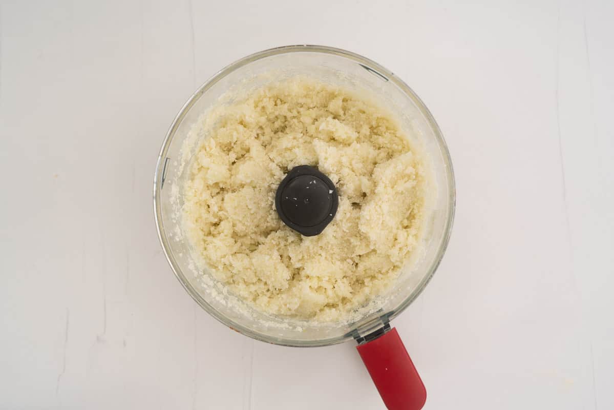 Riced cauliflower and onion in a food processor.