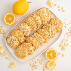 A white rectangular platter with 16 lemon oatmeal cookies.