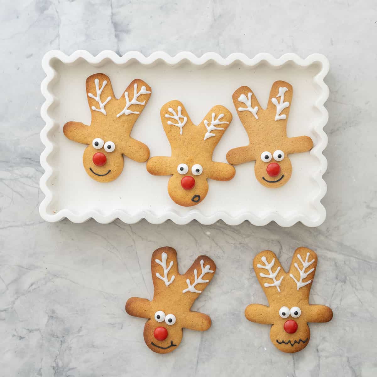 Gingerbread cookies decorated with royal icing and candy to look like reindeer. 