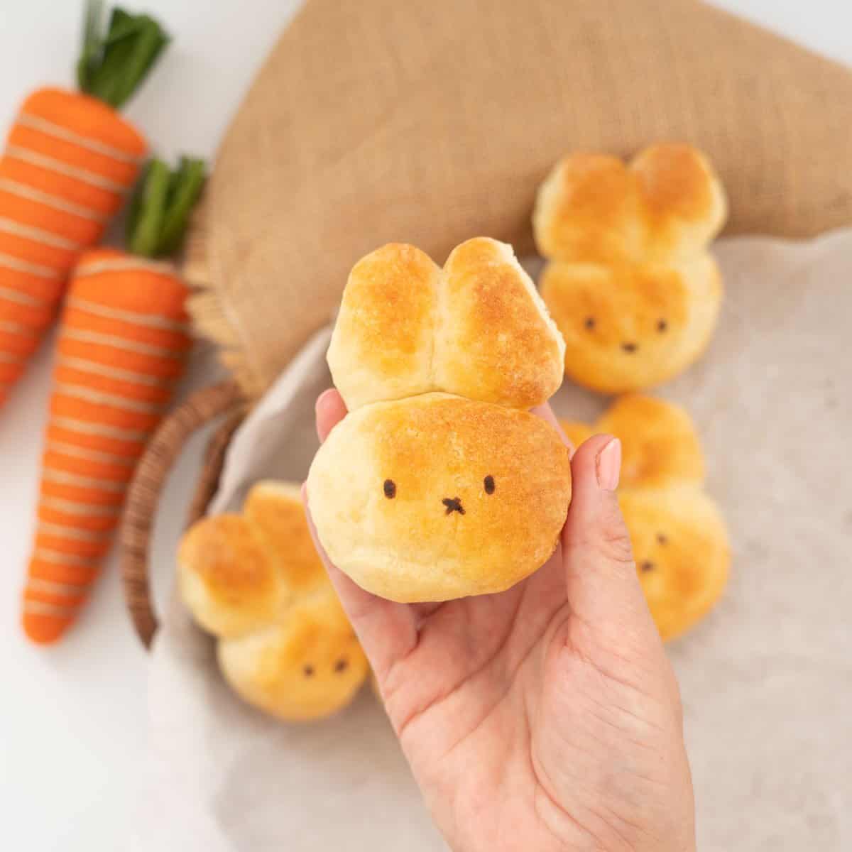 A bread roll baked into the shape of a bunny face with 2 ears.