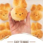 A bread roll baked into the shape of a bunny face with 2 ears with text overlay