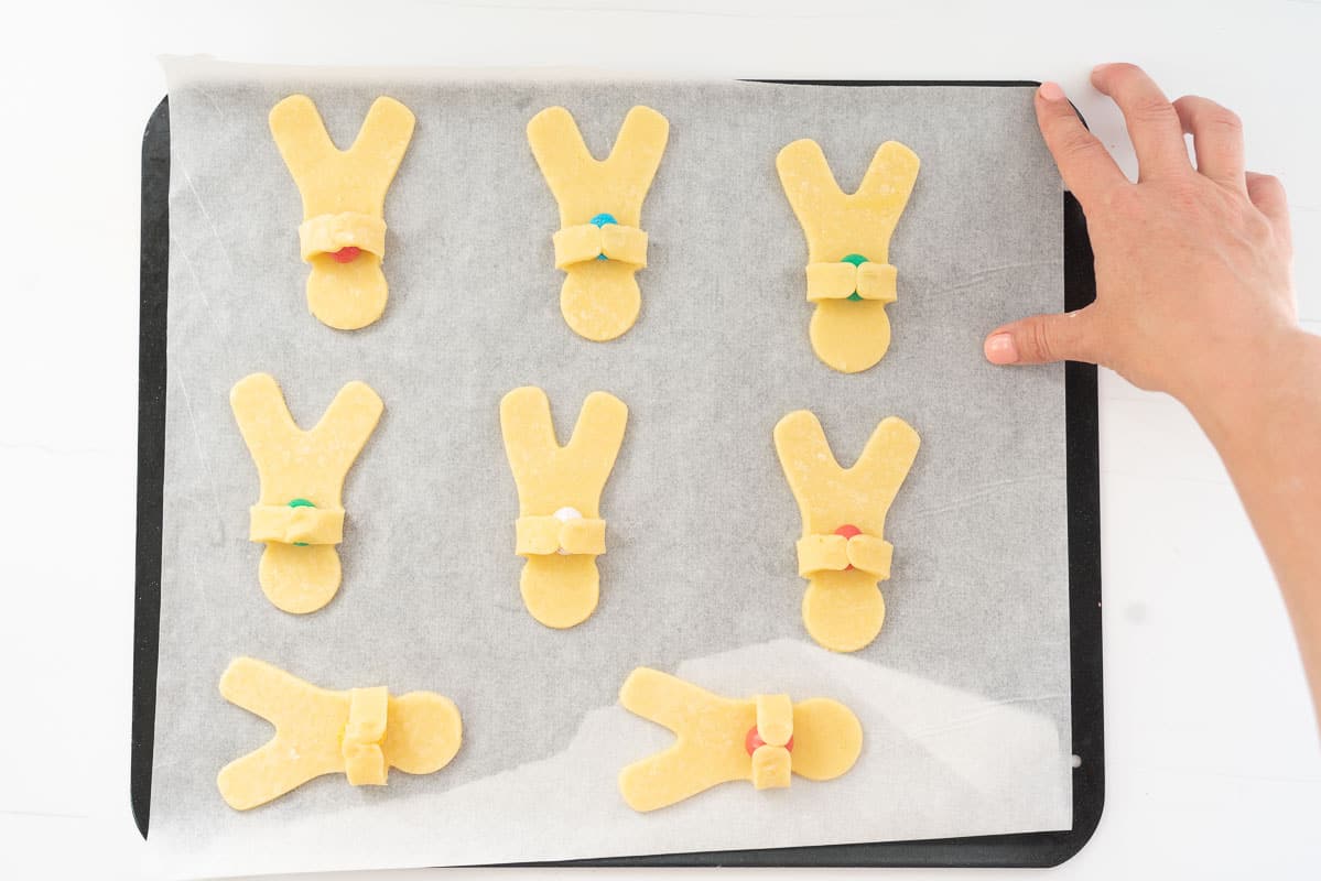 gingerbread man cookies with arms folded over to hold a mini easter egg.