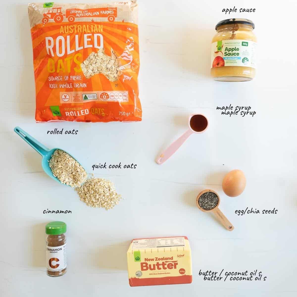 The ingredients to make apple flavoured oatmeal bars laid out on bench top with text overlay.
