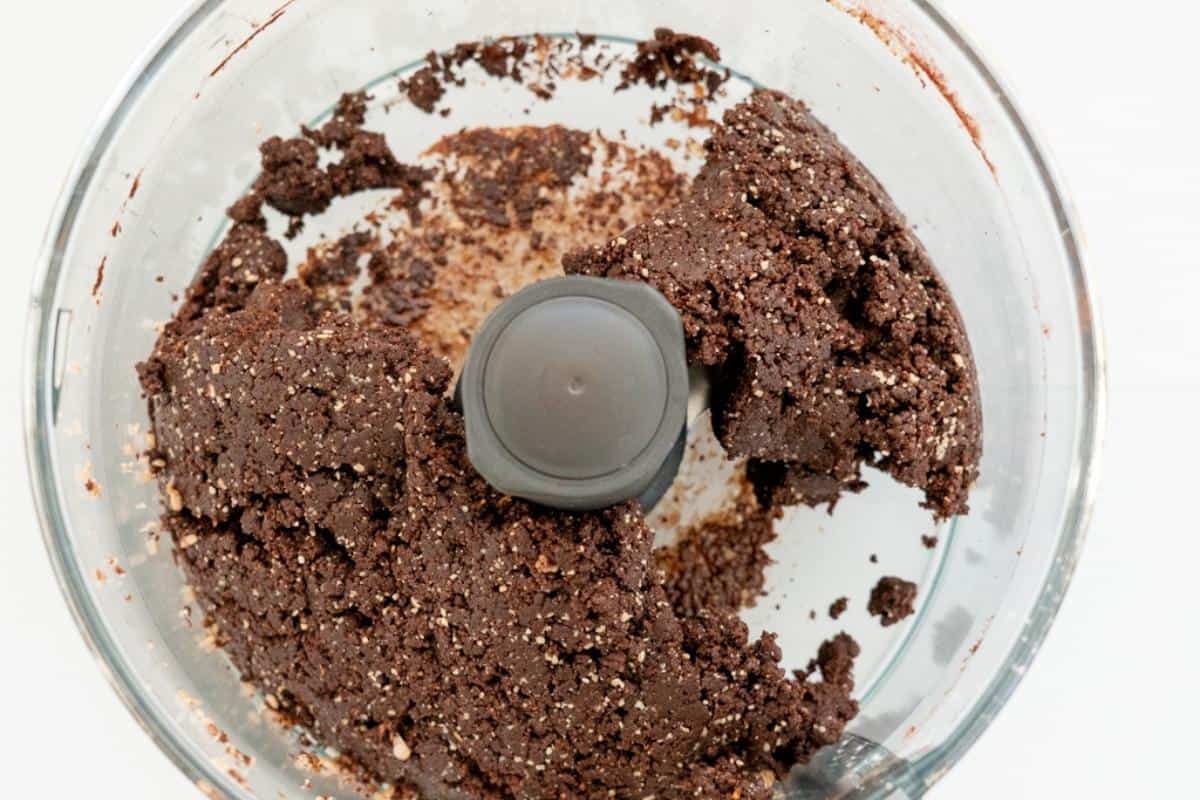 Chocolate weetbix slice mix in the bottom of a food processor. 