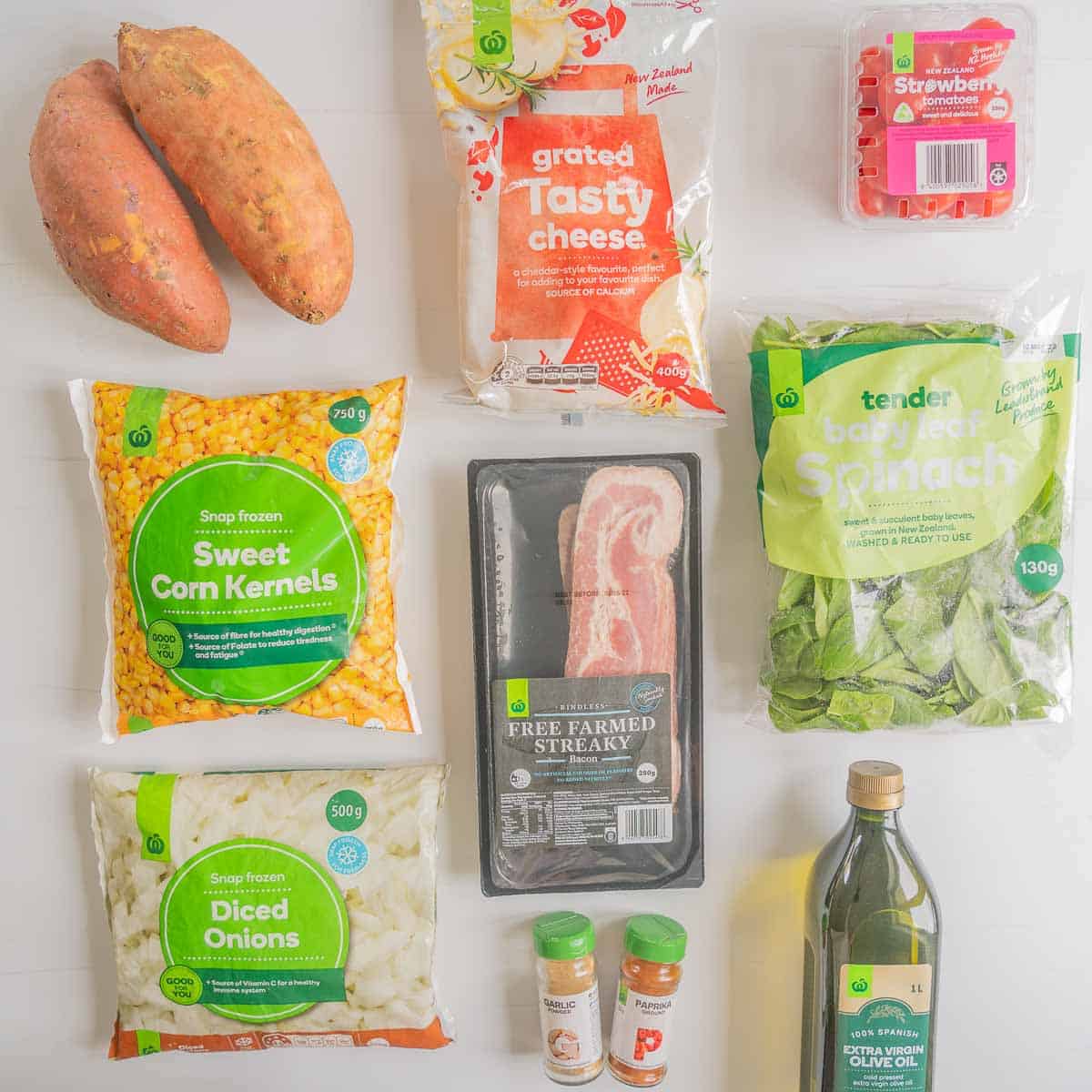 The ingredients to make loaded kumara chips in their packaging laid out on a bench top.