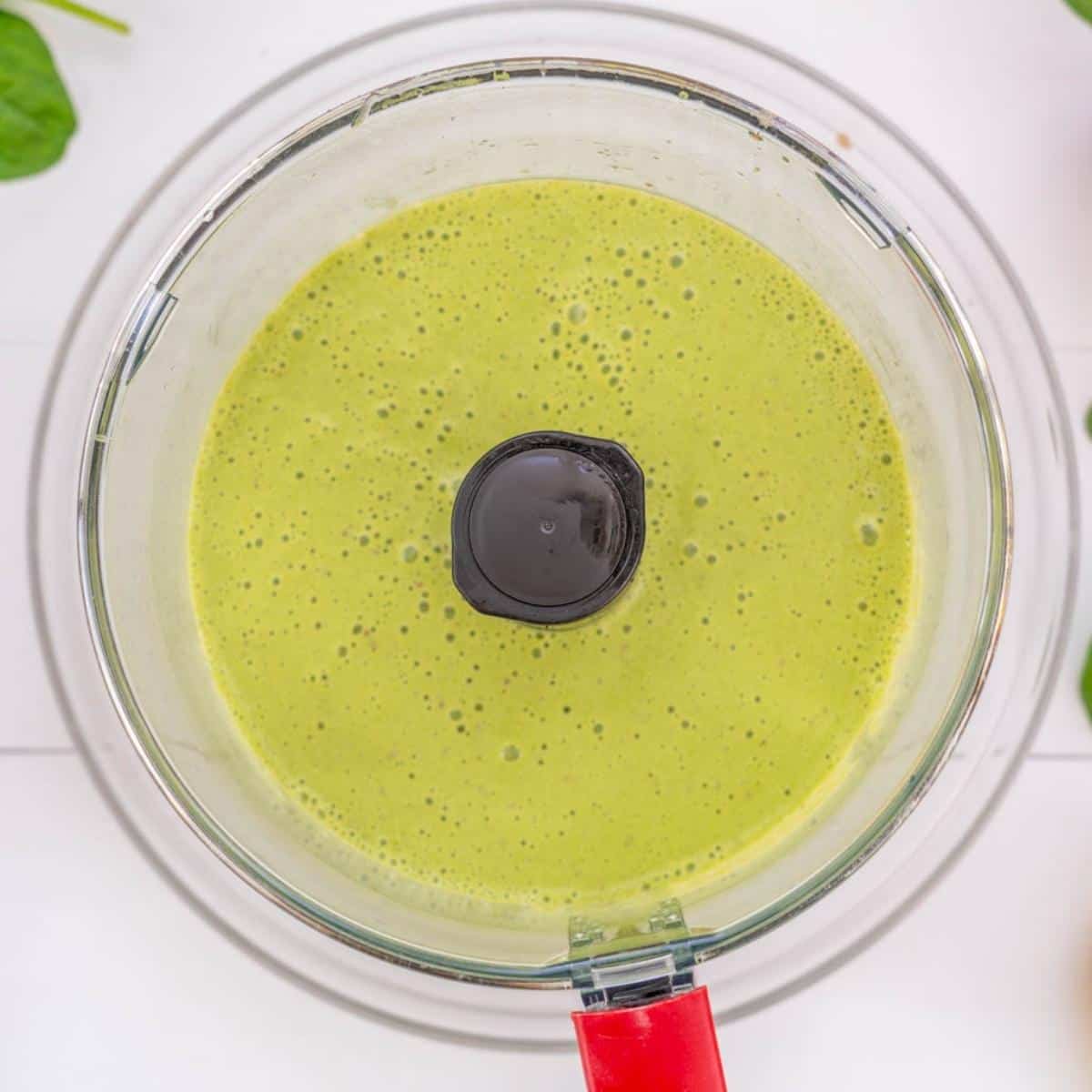 A green smoothie in a food processor. 