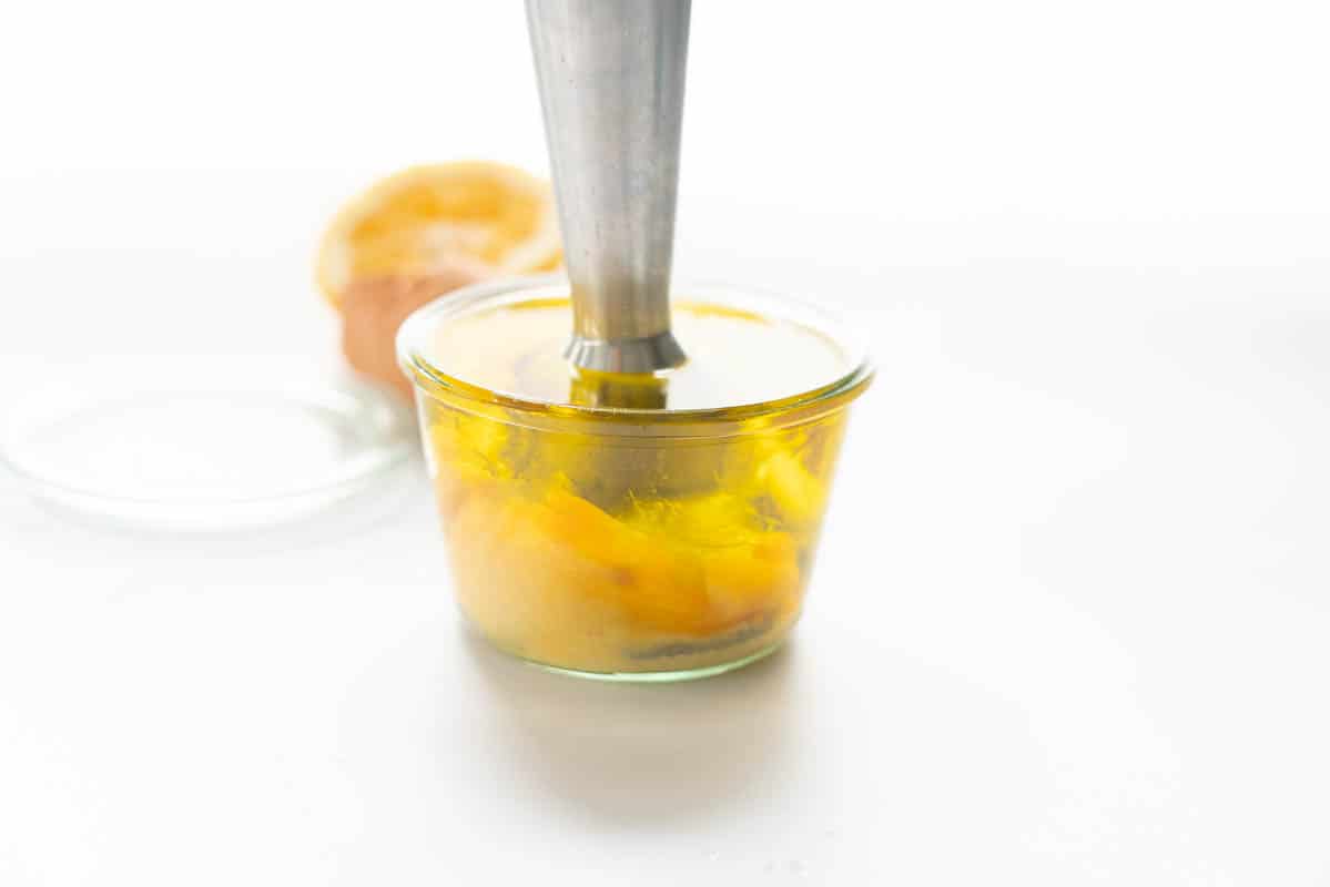 An emulsion blender beginning to emulsify an egg and oil to create mayonnaise.