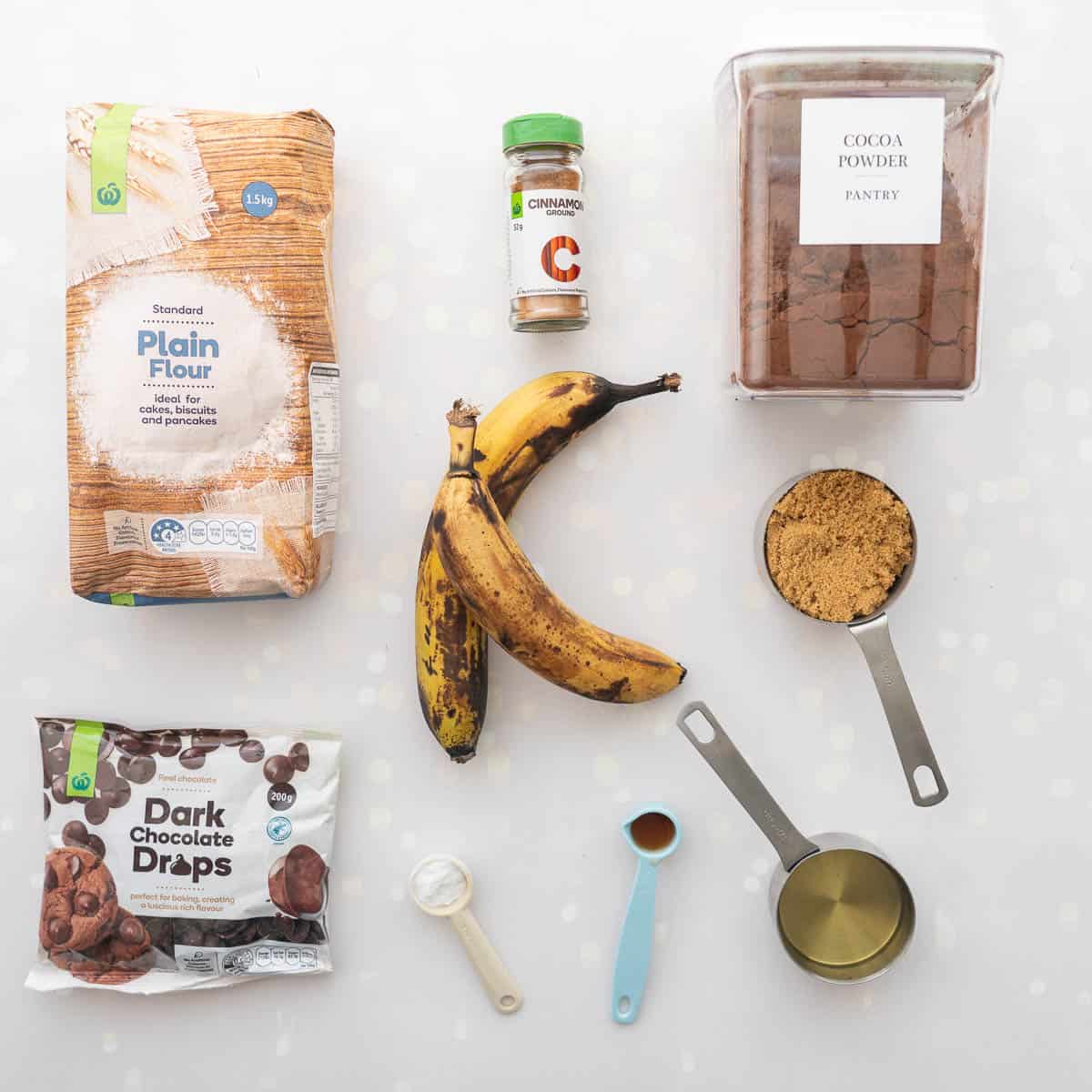The ingredients to make a vegan double chocolate banana bread laid out on a bench top.