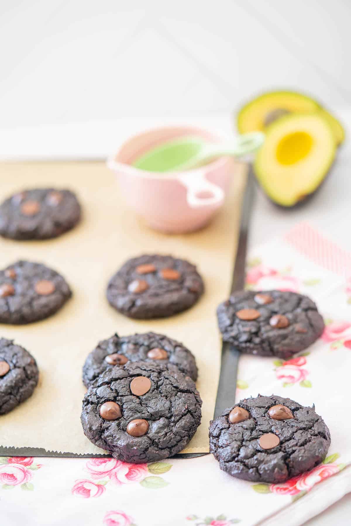 Chocolate cookies scattered on a pink floral tea towel