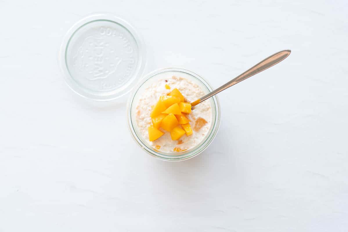 Oats topped with diced peaches.