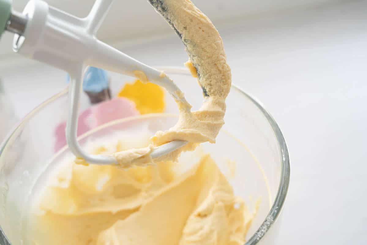 Thick and creamy cupcake batter in a large stand mixer. 