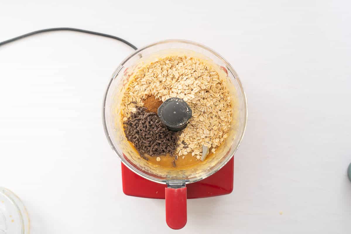 Rolled oats and chocolate chips in a food processor with chickpea puree