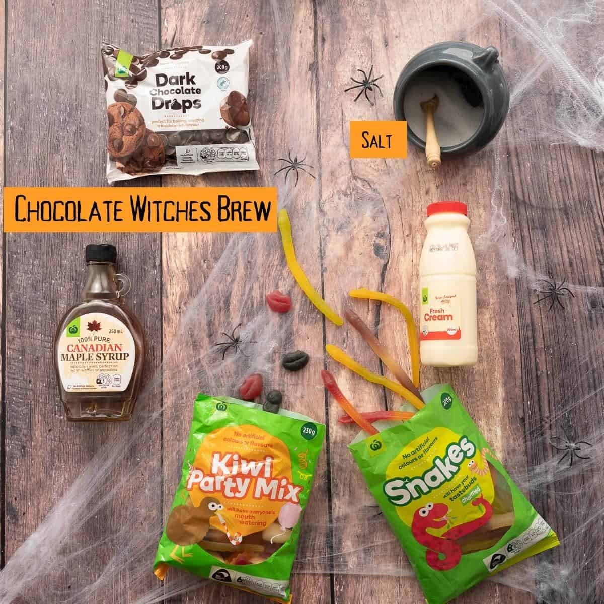 The ingredients to make chocolate witches brew dip laid out on a dark wooden table top with text overlay.