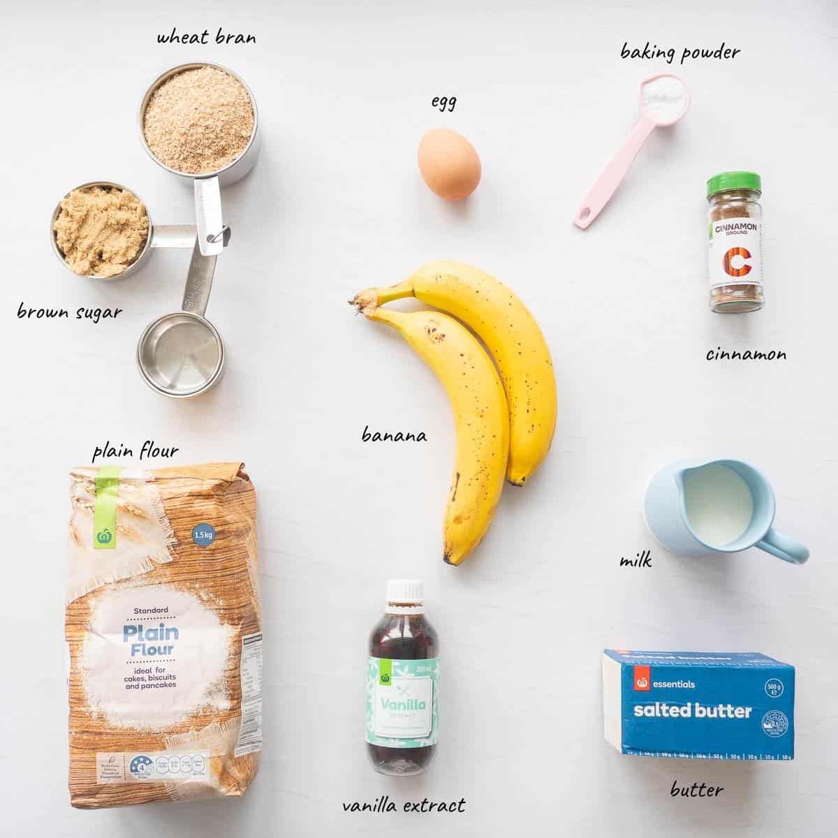 The ingredients to make banana bran muffin laid out on a countertop with text overlay.