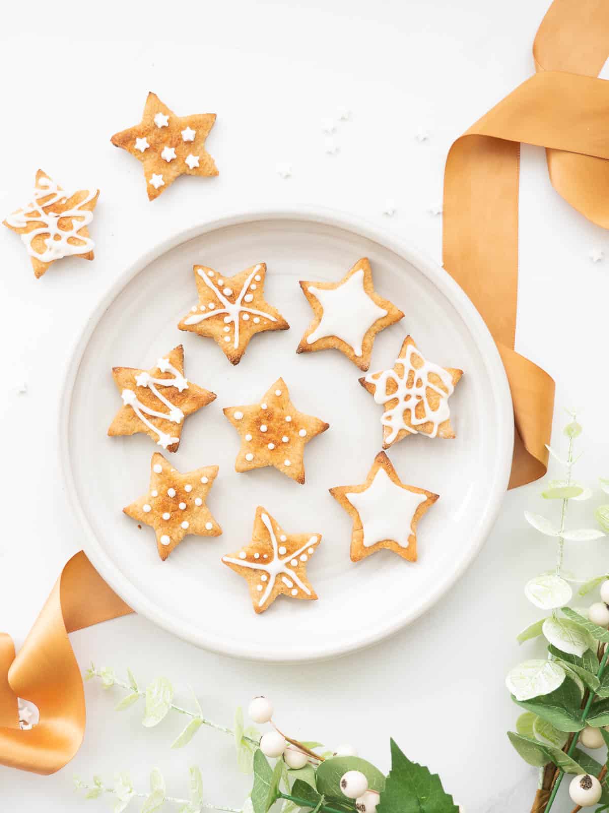 Star shaped cookies decorated with white royal icing. 