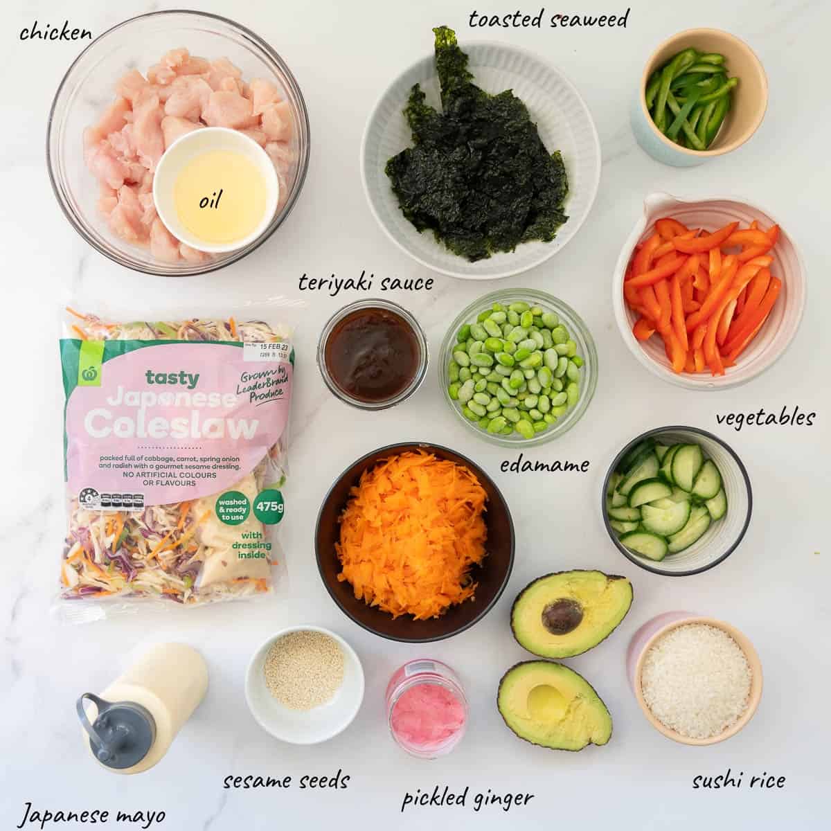 The ingredients to make sushi bowls laid out on a bench to with text overlay.