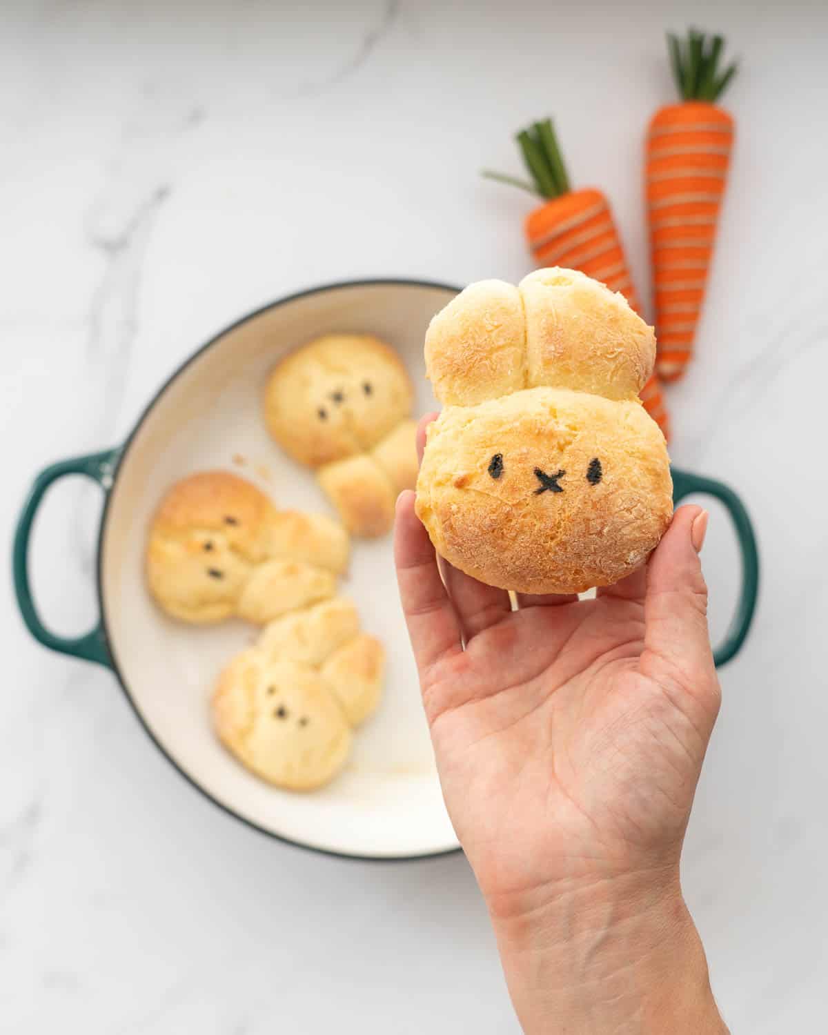 A gluten free dinner roll baked into the shape of a bunny face with 2 ears.