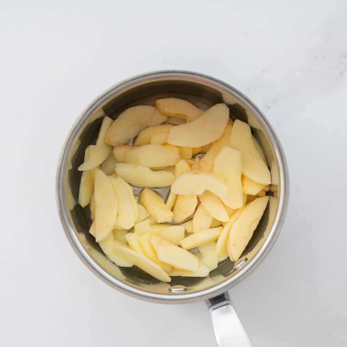 Apple slices in a small sauce pan.