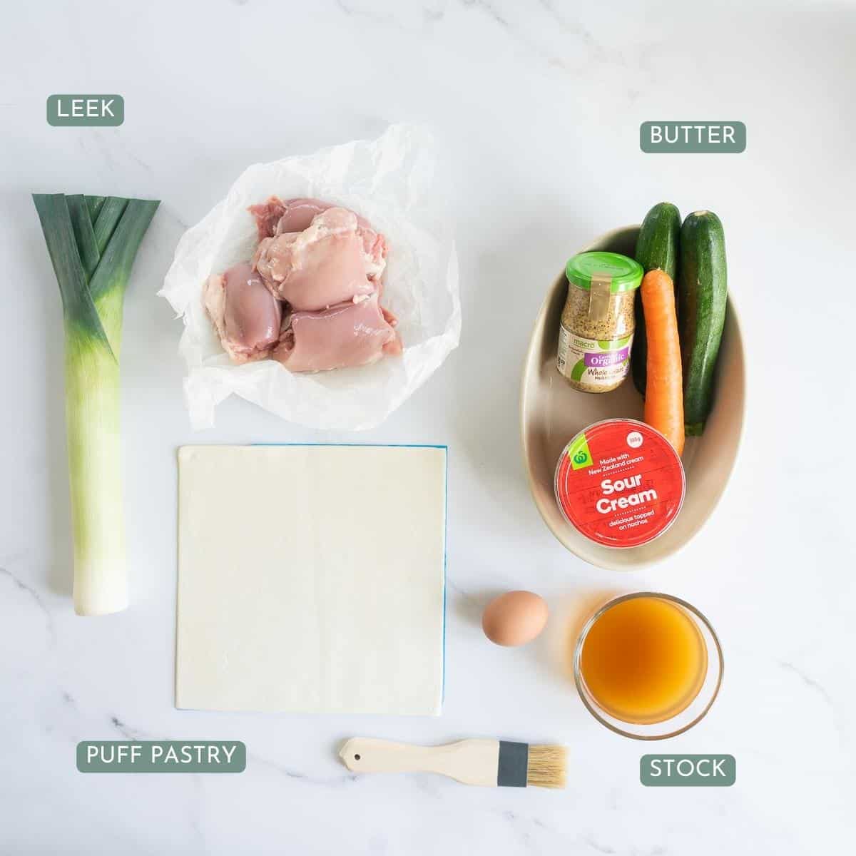 The ingredients to make chicken leek pie laid out on bench top with text overlay.