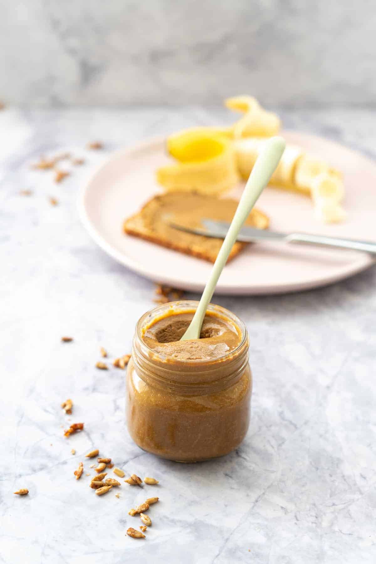 Jar of spread with a spoon in it.