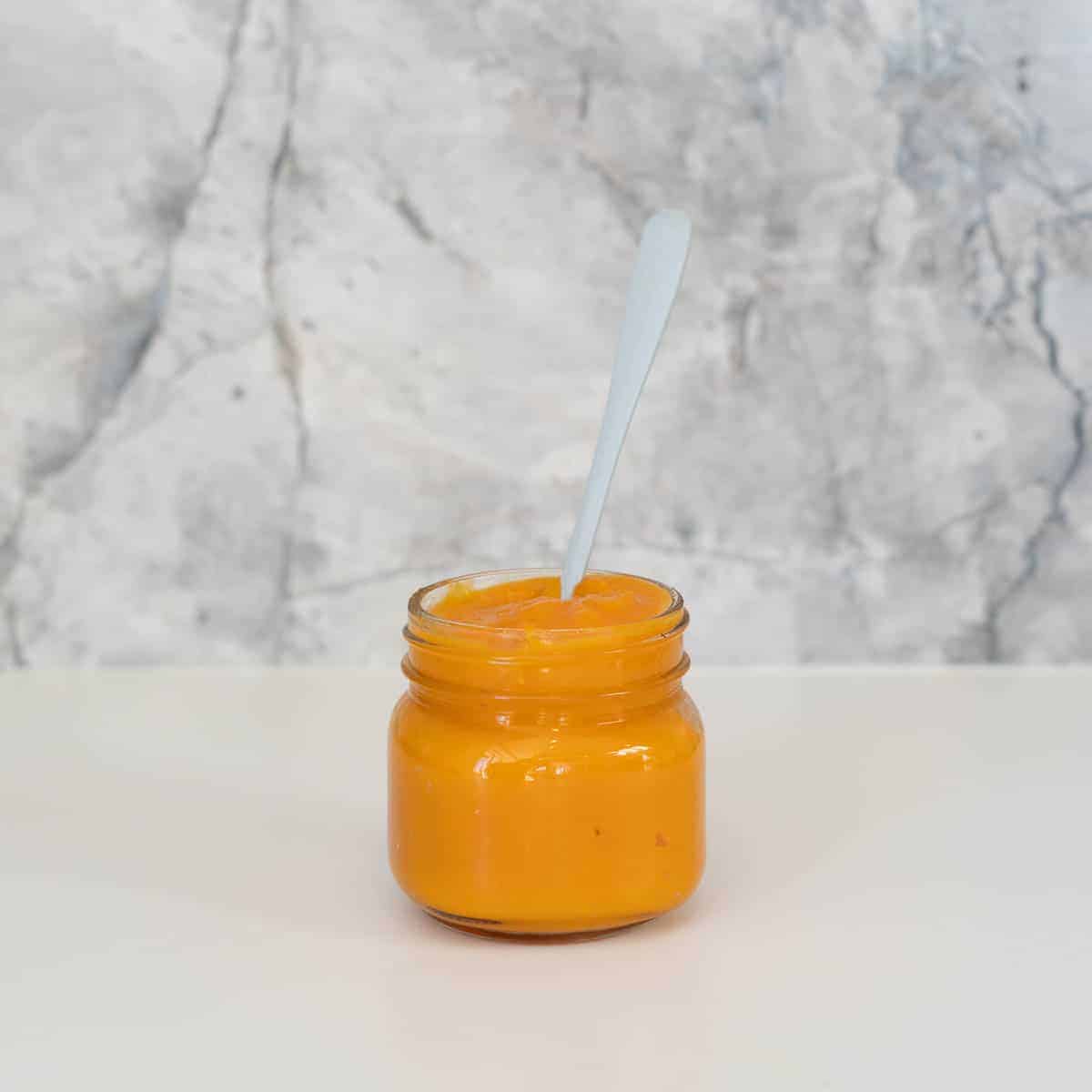 A jar of orange puree