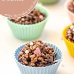 Chocolate crackles in multi coloured reusable silicone cupcake liners on a white bench top scattered with heart shaped sprinkles with text overlay for pinterest.