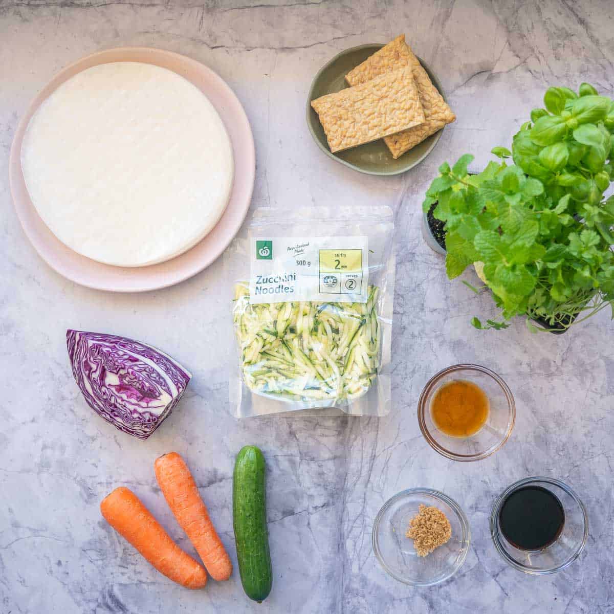 The ingredients to make tofu and vegetable rice paper rolls laid out on a bench top.