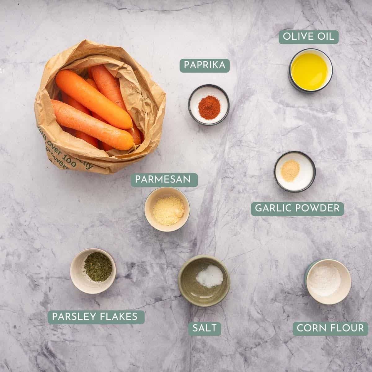 The ingredients to make carrot fries laid out on a bench top with text overlay.
