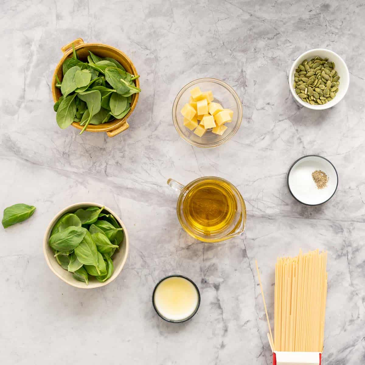 All the ingredients to make the Pesto Pasta laid out on the bench in small ramekins and jugs