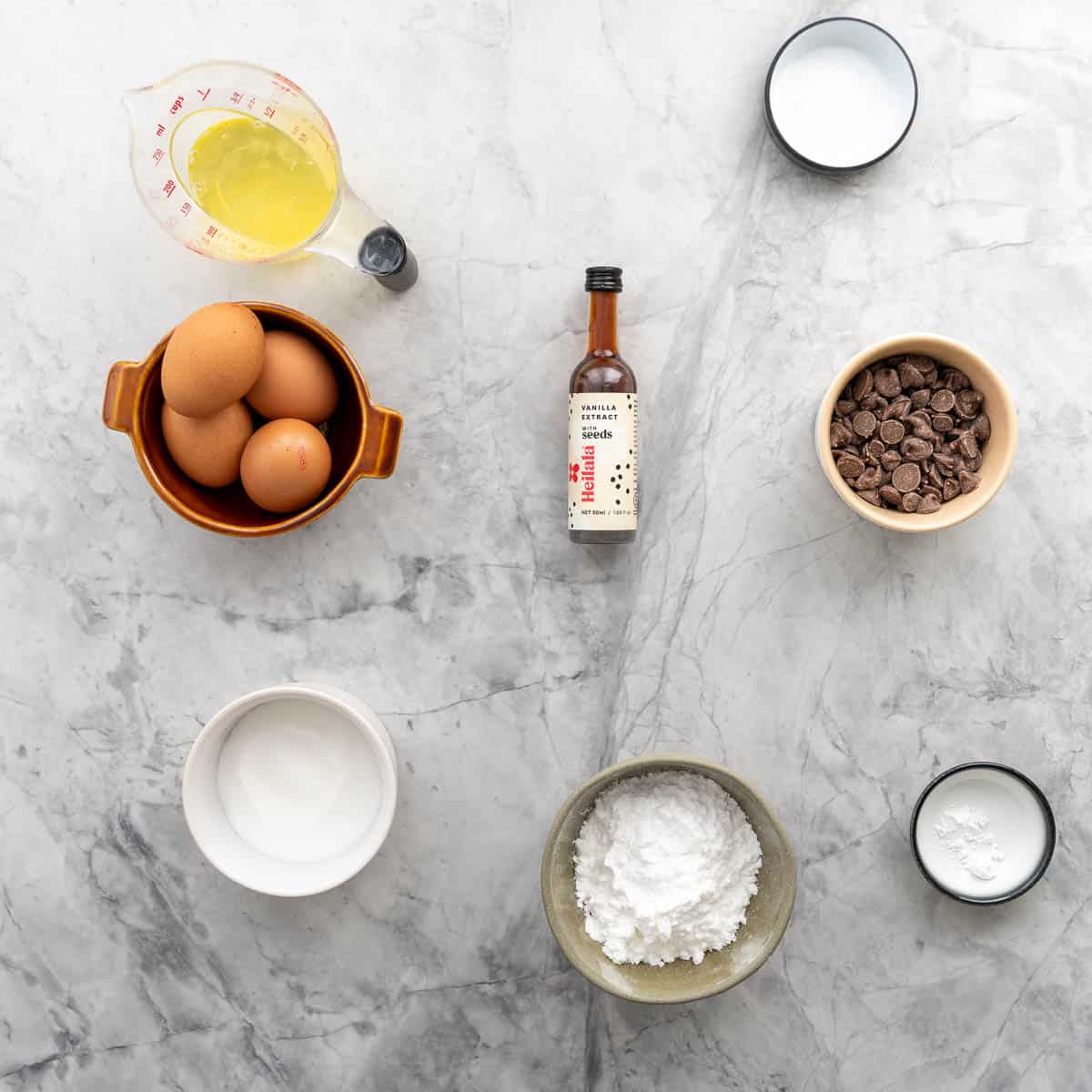 The ingredients to make meringue cookies laid out on a bench top