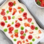 Yogurt bark in a sheet pan studded with red white and green ingredients.