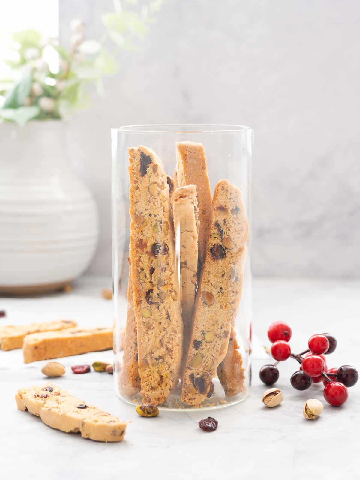 A tall glass jar filled with biscotti