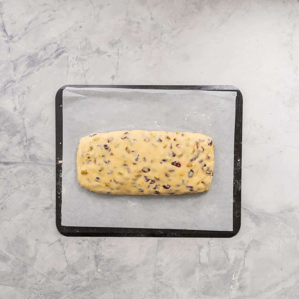 A rectangular slab of biscotti dough ready to go into the oven. 