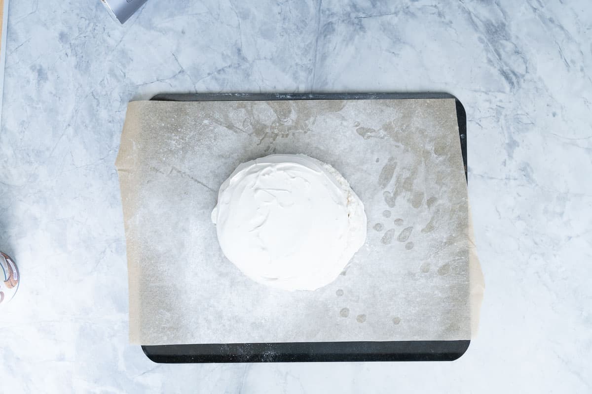A baked pavlova on a baking sheet