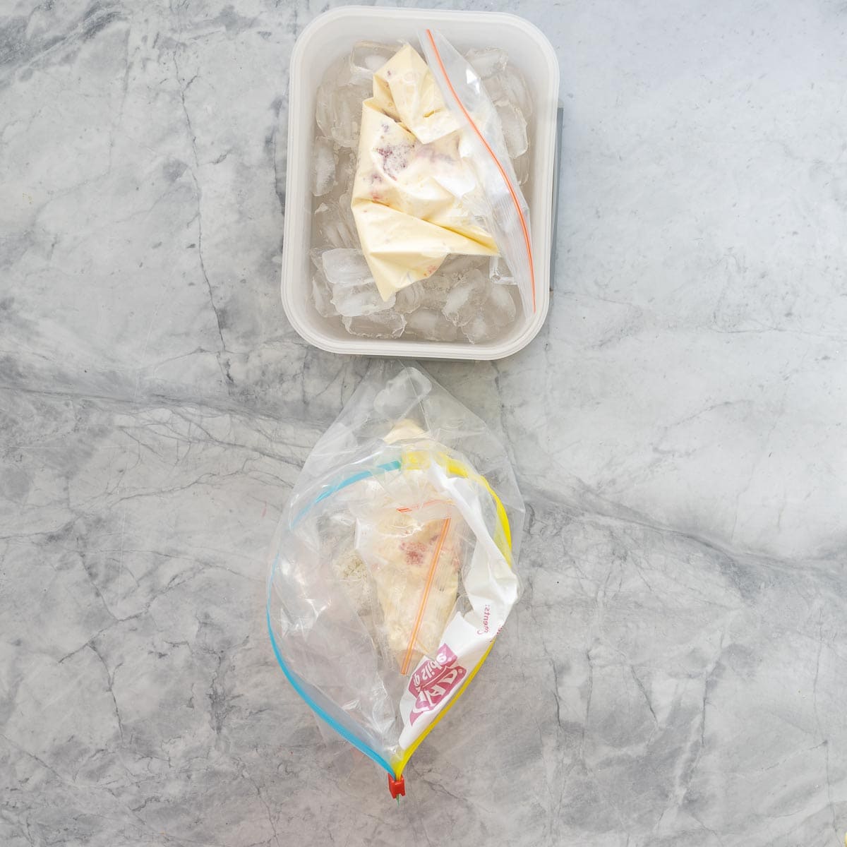 A small zip lock bag of ice cream ingredients inside a big zip lock bag of ice and salt. 
