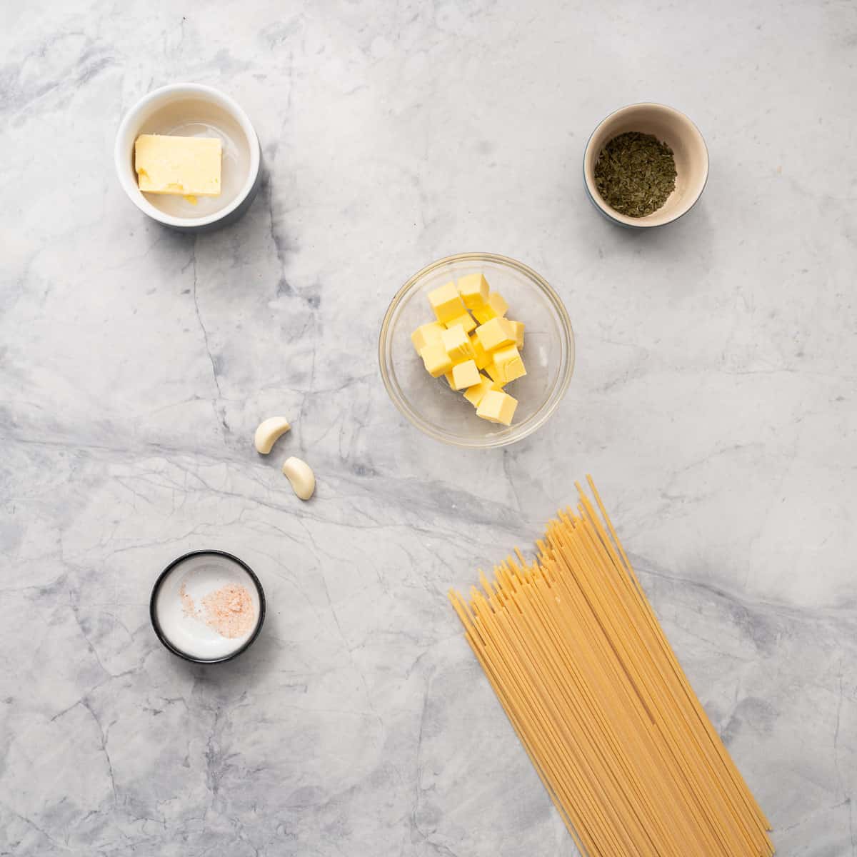 All the ingredients to make the buttered noodles resting on the bench 
