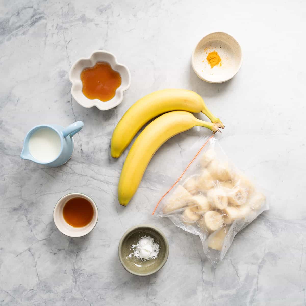 All the ingredients to make the banana popsicles laid out on the bench. 