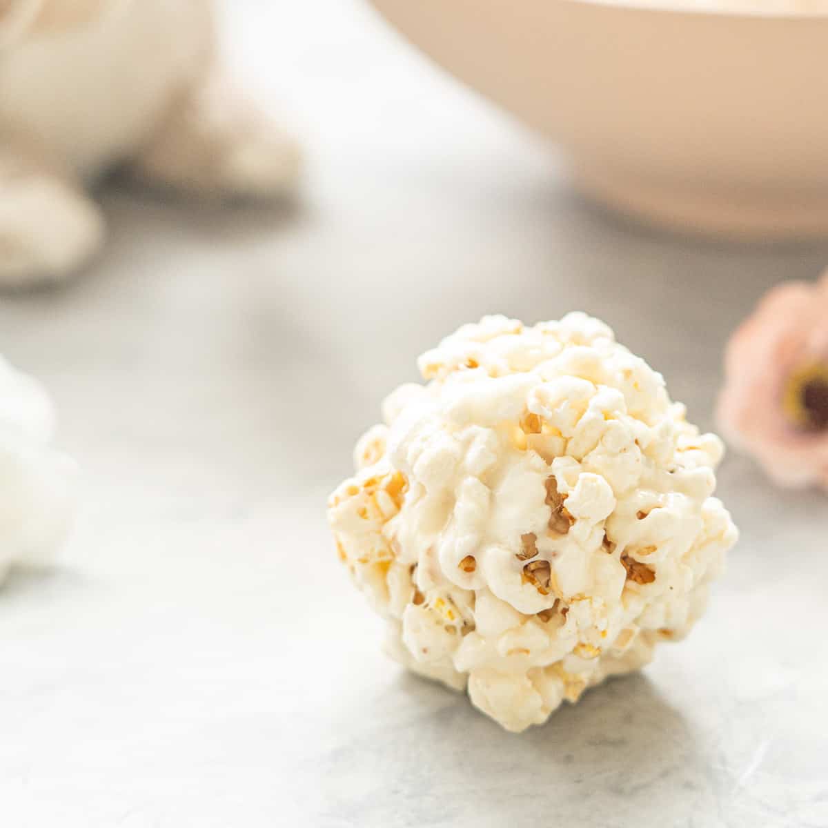 Close up of a popcorn ball on a marble bench.