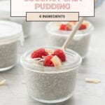 A small glass container of coconut chia pudding topped with raspberries and coconut flakes, wood spoon in bowl with text overlay for Pinterest.