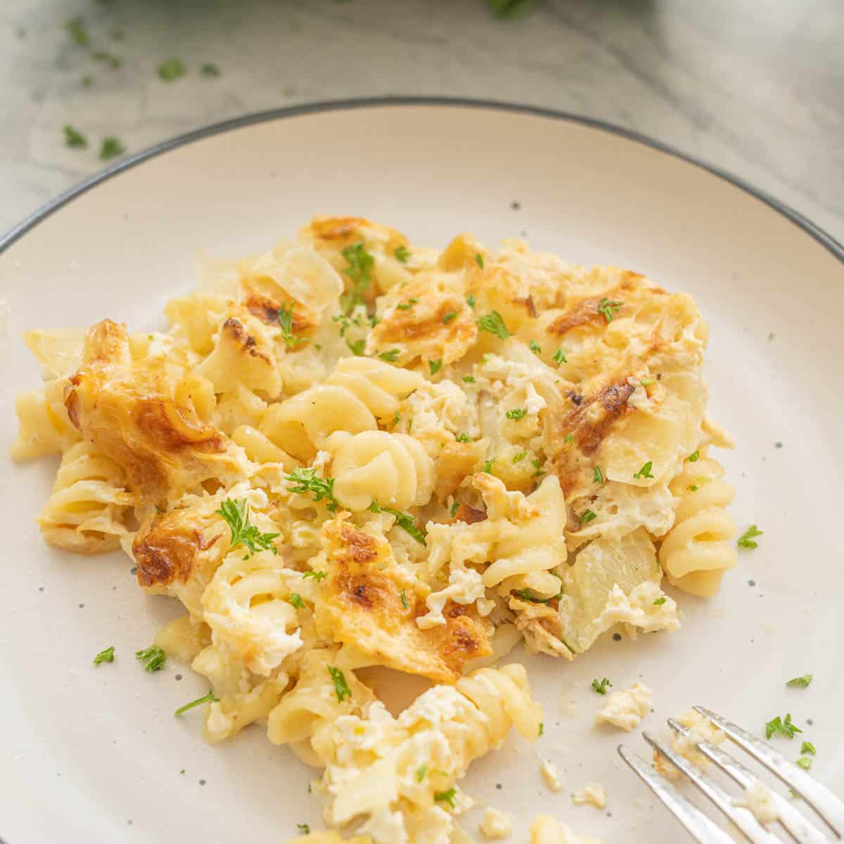 Close up of cauliflower pasta bake on dinner plate.