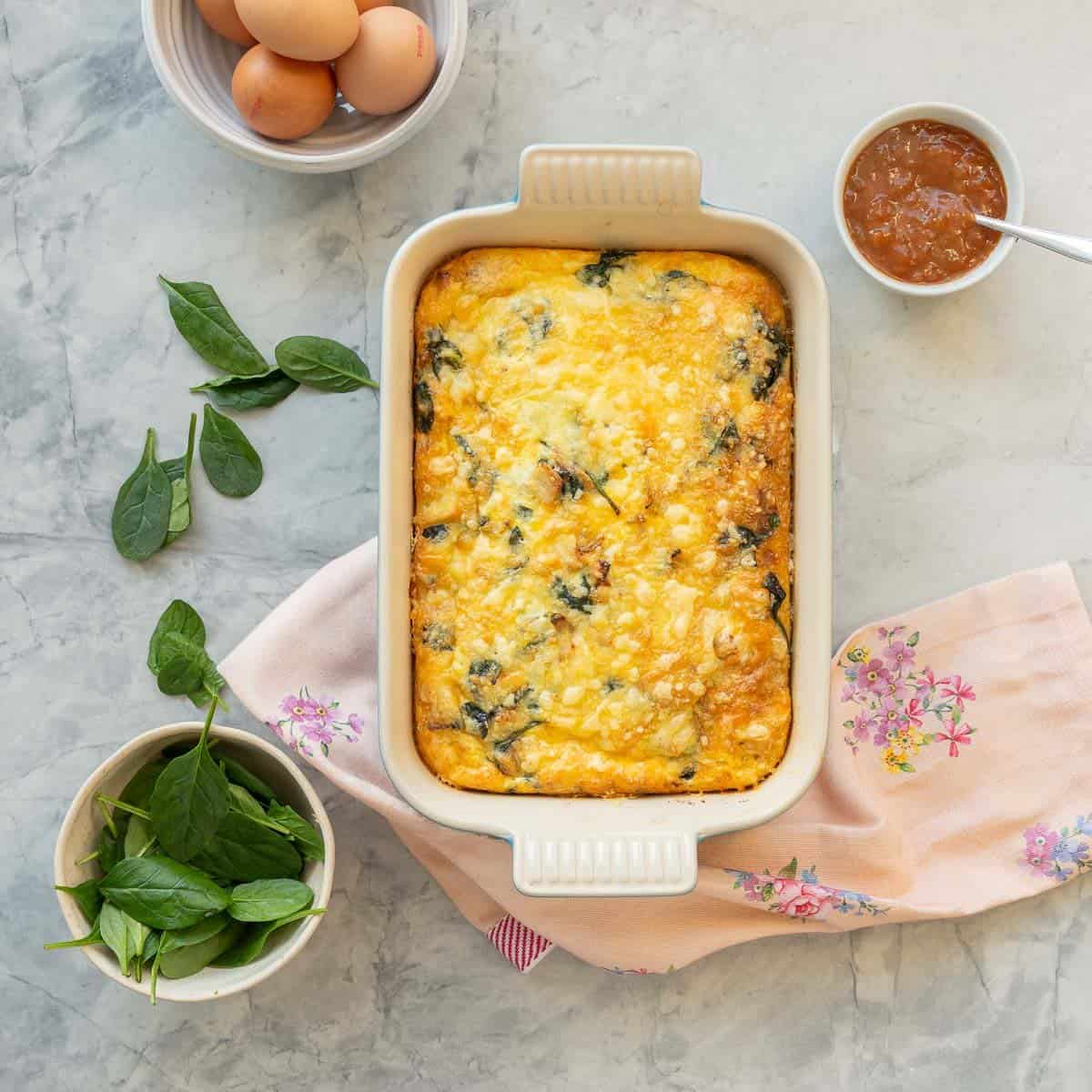 Egg bake hash brown after being cooked in baking dish on bench top.