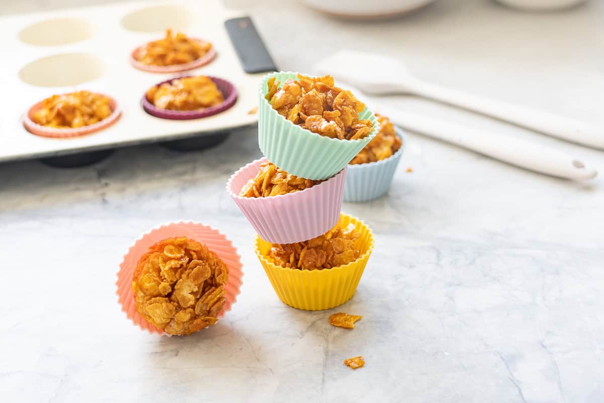 Three cornflake honey clusters stacked on top of each other.