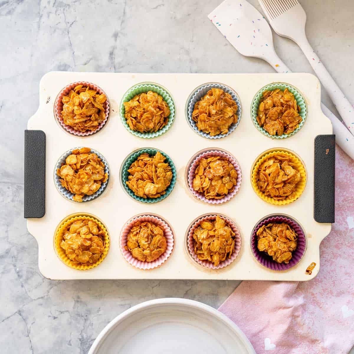 12 cornflake clusters in a muffin tray.