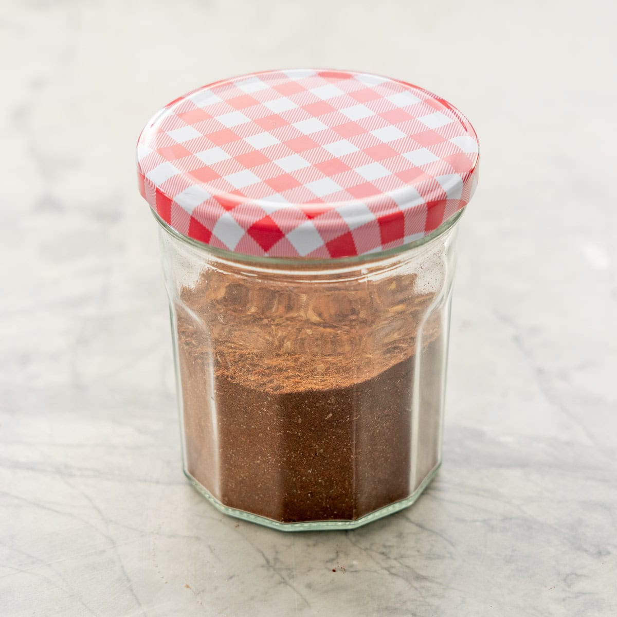 Jar of mexican seasoning with lid on.