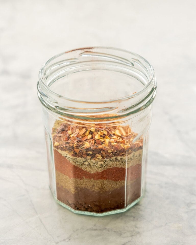 Mexican seasoning ingredients layered in a jar.