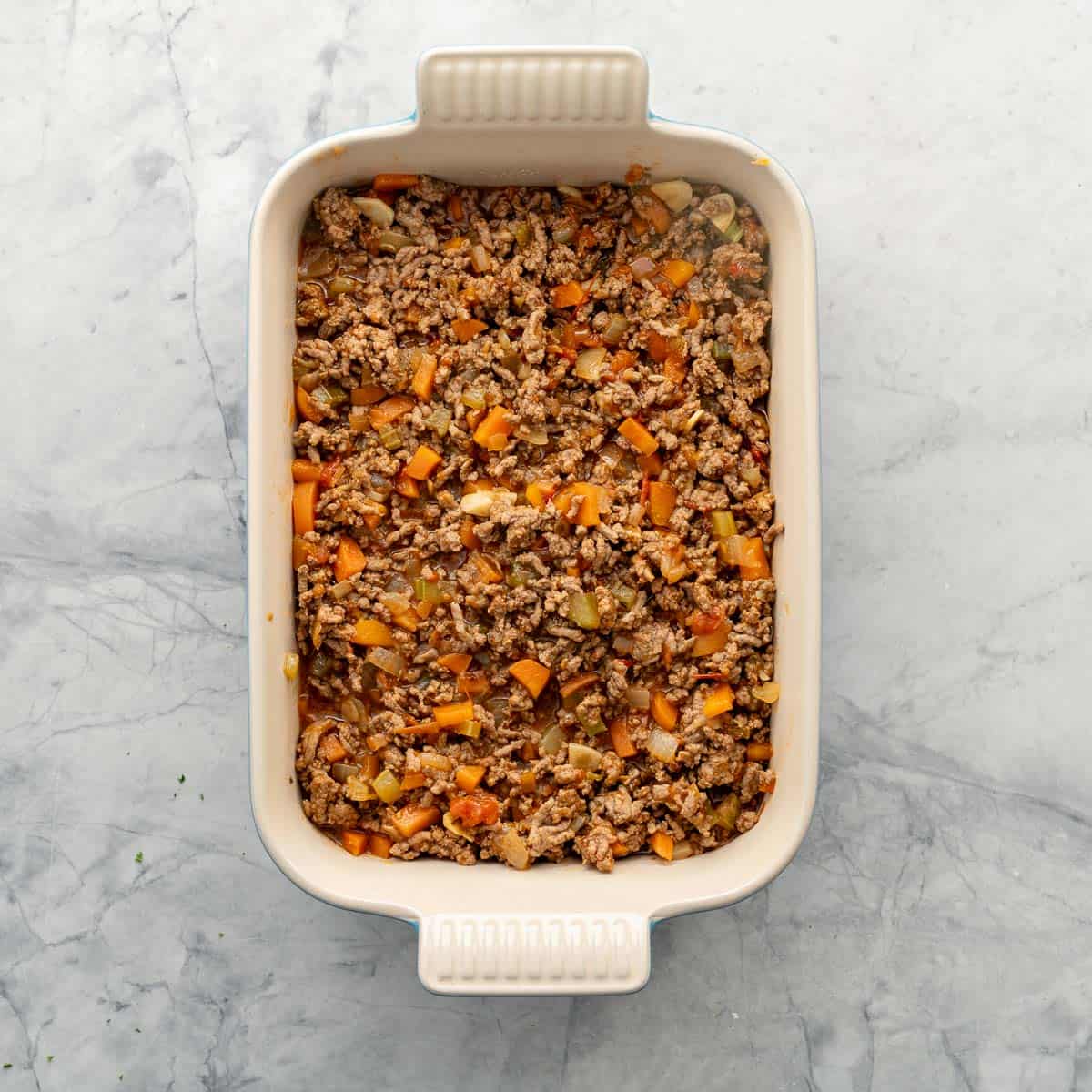 Mince and vege mixture in baking dish.