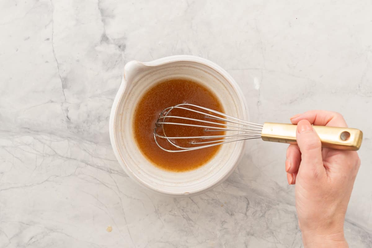 Hand whisking the wet ingredients together in small bowl.