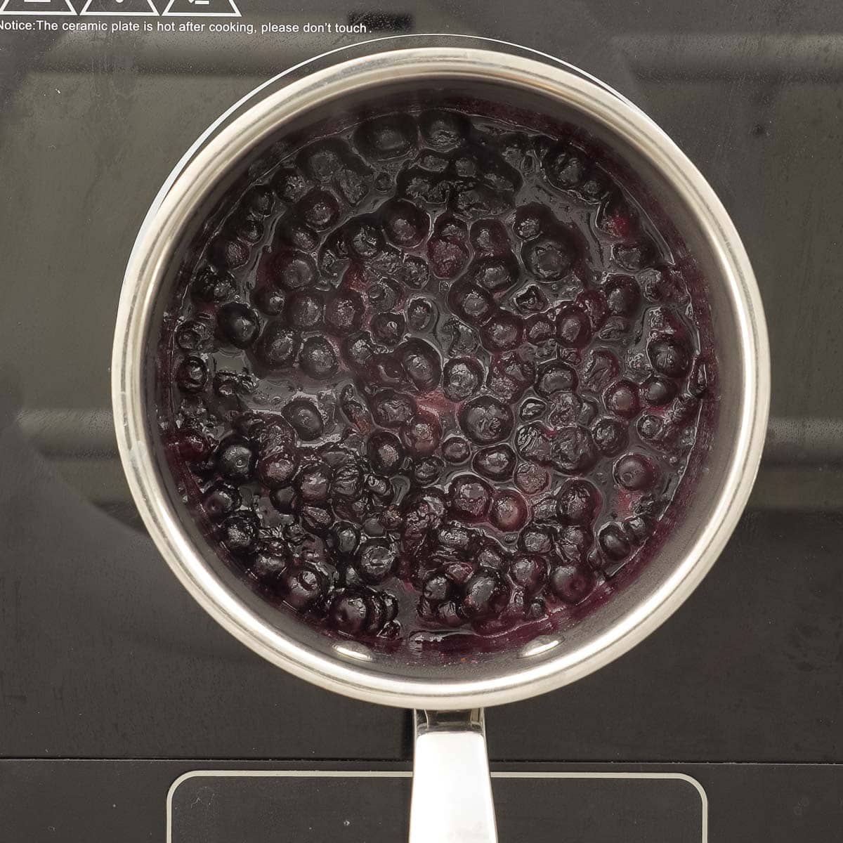 Blueberries in pot on stove.