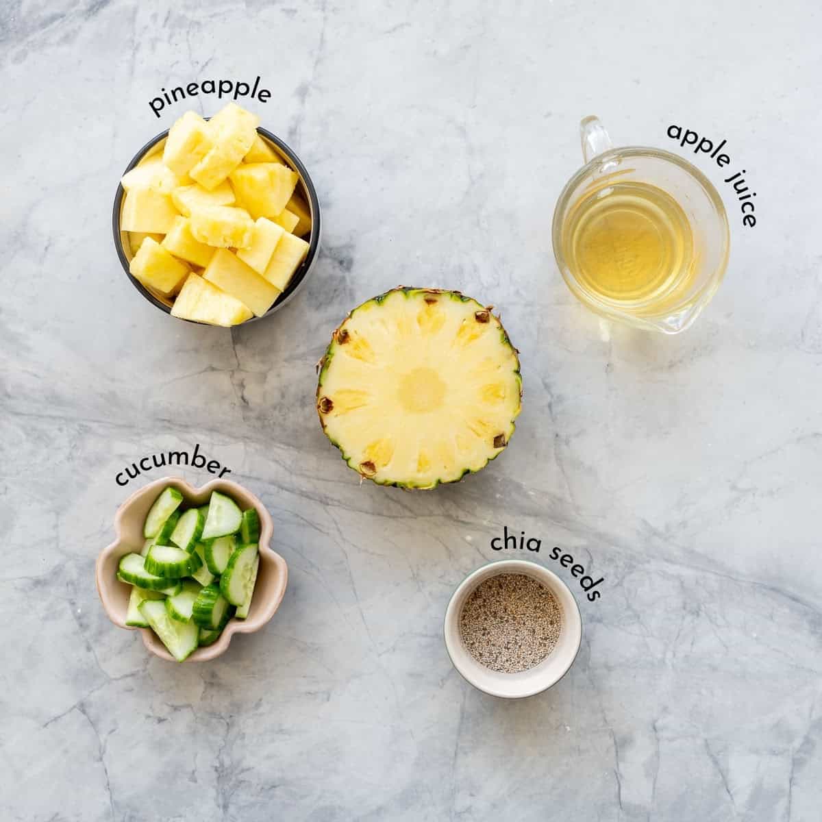 Ingredients for Pineapple cucumber smoothie on bench top with txt overlay labels.